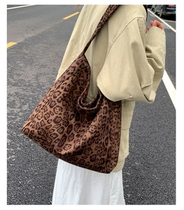 Scatto street style all'aperto che mostra la capienza della borsa tote leopardata su una modella