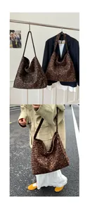 Macro detail of high-capacity leopard print tote bag showing fabric texture and shoulder strap