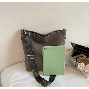 Detail of large canvas bucket bag featuring ethnic geometric print wide strap and large capacity