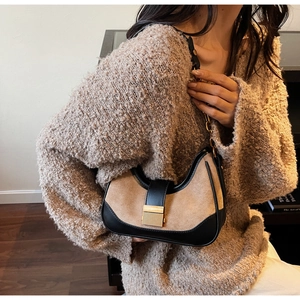 Retro contrast color shoulder bag in brown suede and black leather on a model