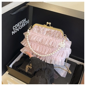 Détail du sac de soirée en dentelle rose avec poignée en perles et fermoir vintage
