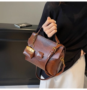Detail view of retro brown faux oil leather tote bag with small matching hanging pouch