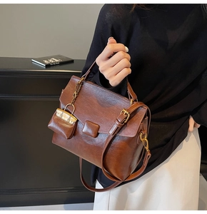 Brown vintage faux leather crossbody bag with square buckle and mini coin purse detail