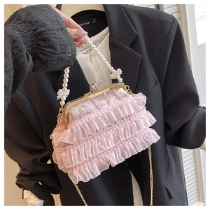 Détail du sac en tulle rose avec poignée en perles, fermoir doré et chaîne en métal