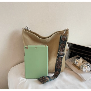 Detail of khaki canvas tote with ethnic embroidered strap showing large capacity for tablets