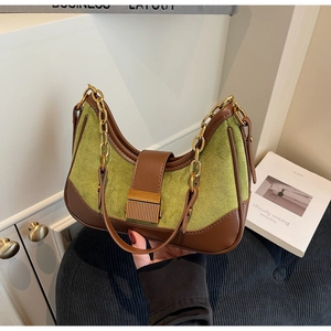 Close-up of contrast stitch shoulder bag with olive suede and brown leather detailing