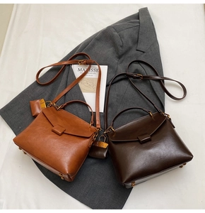 Detail of vintage flap crossbody bags in brown and dark coffee with mini pouch