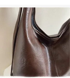 Close-up of soft brown faux leather tote with textured surface and premium finish