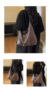 Detailed view of large dark brown hobo tote bag in glossy soft leather with slouchy design