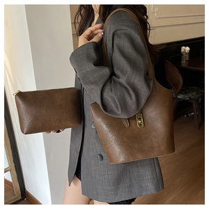 Detail of vintage brown tote bag set with metal twist lock and matching small pouch