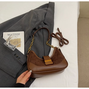 Detail of vintage brown hobo bag showing contrast textures of suede and leather materials