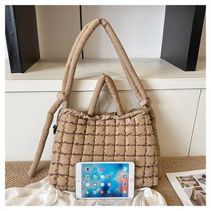 Détail du sac fourre-tout matelassé kaki avec bandoulière nouée et texture en nylon