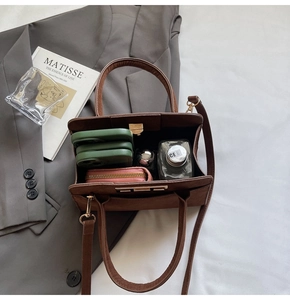 Interior view of large brown tote bag showing spacious storage for phone and wallet
