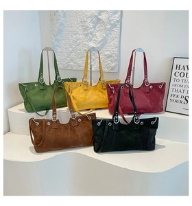 Detail of suede tote bags in five colors showing metallic eyelets and adjustable straps