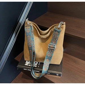 Detail of canvas bucket bag with ethnic geometric wide shoulder strap and metal hook