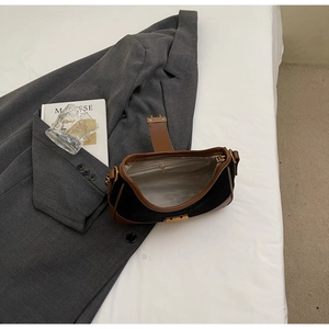 Detailed view of the vintage suede handbag interior zipper pocket and leather strap