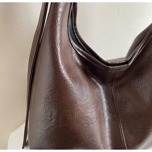 Close-up of deep brown large-capacity tote bag with vintage oil wax leather texture