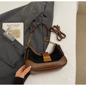 Detail view of contrast vintage handbag with gold chain strap and textured leather finish