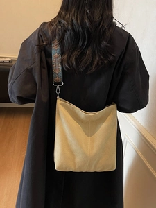 Minimalist khaki canvas bucket bag with ethnic patterned strap and large capacity