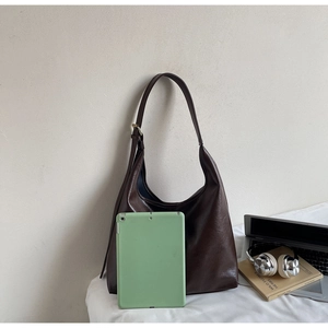 Deep brown large hobo bag with pebble leather texture showing iPad storage capacity