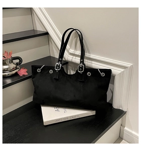 Detail view of black vintage tote bag with silver eyelets and premium matte texture surface