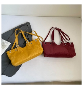 Detail of vintage tote bags in ginger yellow and wine red with matte texture