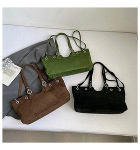 Flat lay of vintage suede tote bags in olive, brown and black with silver eyelets