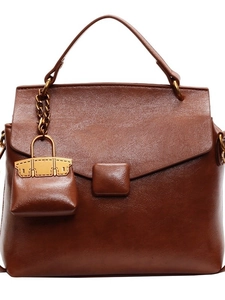 Caramel brown vintage leather handbag with envelope flap and mini purse charm