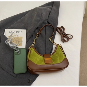Detail of hobo bag with avocado green suede, brown leather trim, and golden buckle