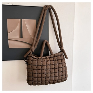 Détail du sac matelassé marron chocolat avec motifs carrés et bandoulière à nœud élégant