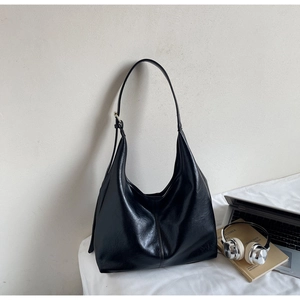 Detailed view of the black leather hobo bag showing its smooth texture and spacious interior