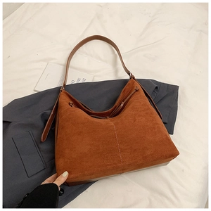 Detail of vintage brown suede tote bag featuring white contrast stitching and soft texture
