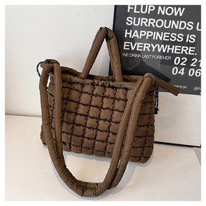 Détail du sac fourre-tout matelassé marron foncé avec texture en nylon brillant et rembourré