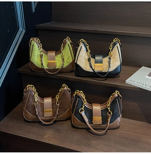 Four retro color-block underarm bags on a wooden staircase with golden chain details