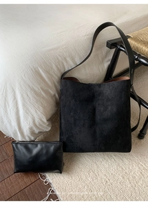 Detail-Set aus schwarzer Wildleder-Shopper-Tasche und passender kleiner Reißverschlusstasche