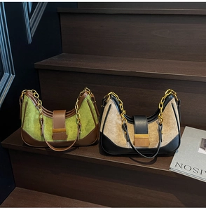 Detail of retro hobo bags with contrast colors, suede texture and gold metal chains