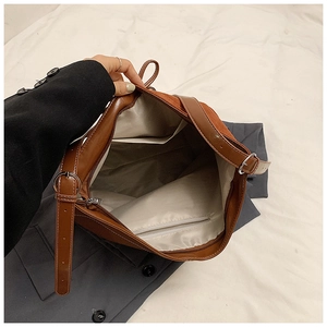 Interior view of vintage caramel tote bag with zipper pocket and adjustable strap