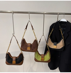 Detail of four retro hobo bags with contrast colors and gold chain leather straps