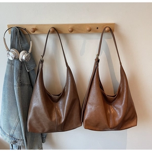 Close-up of vintage brown hobo bags with soft leather texture for daily commute
