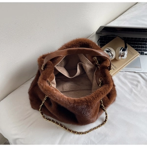 Detailed top view of brown faux fur handbag showing inner pocket and gold chain strap