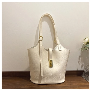 Detail view of large tote bag showing unique cloud texture leather and golden turn-lock