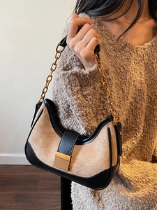 Vintage-style beige suede underarm bag with black leather trim and gold chain strap