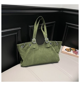 Detail showing vintage green suede fabric and silver metal grommets on large tote bag
