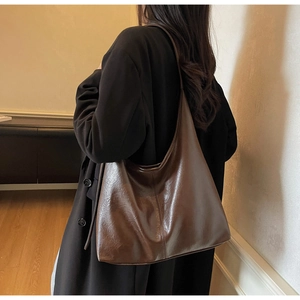 Detailed view of a vintage brown leather tote bag showing large capacity and soft texture