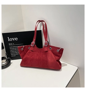 Deep red vintage tote bag detail featuring silver eyelets and adjustable matte strap