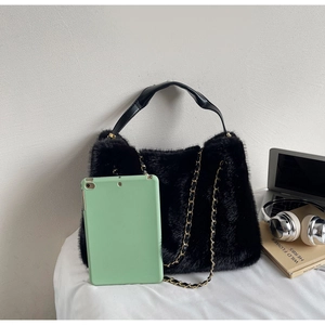 Detail view of the black faux fur texture and gold chain strap on the vintage tote bag