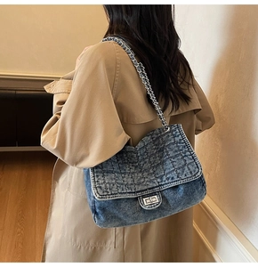 Classic washed denim quilted shoulder bag with chain strap shown on model back