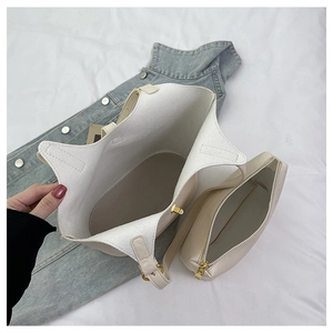 Detail view of large cream tote bag set with matching zipper pouch on denim cloth
