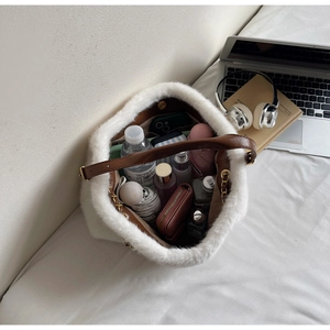 Spacious interior of white faux fur bucket bag showing ample space for daily essentials