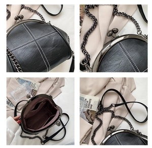Close-up of vintage shell bag showing metal clasp and internal multi-pocket lining
